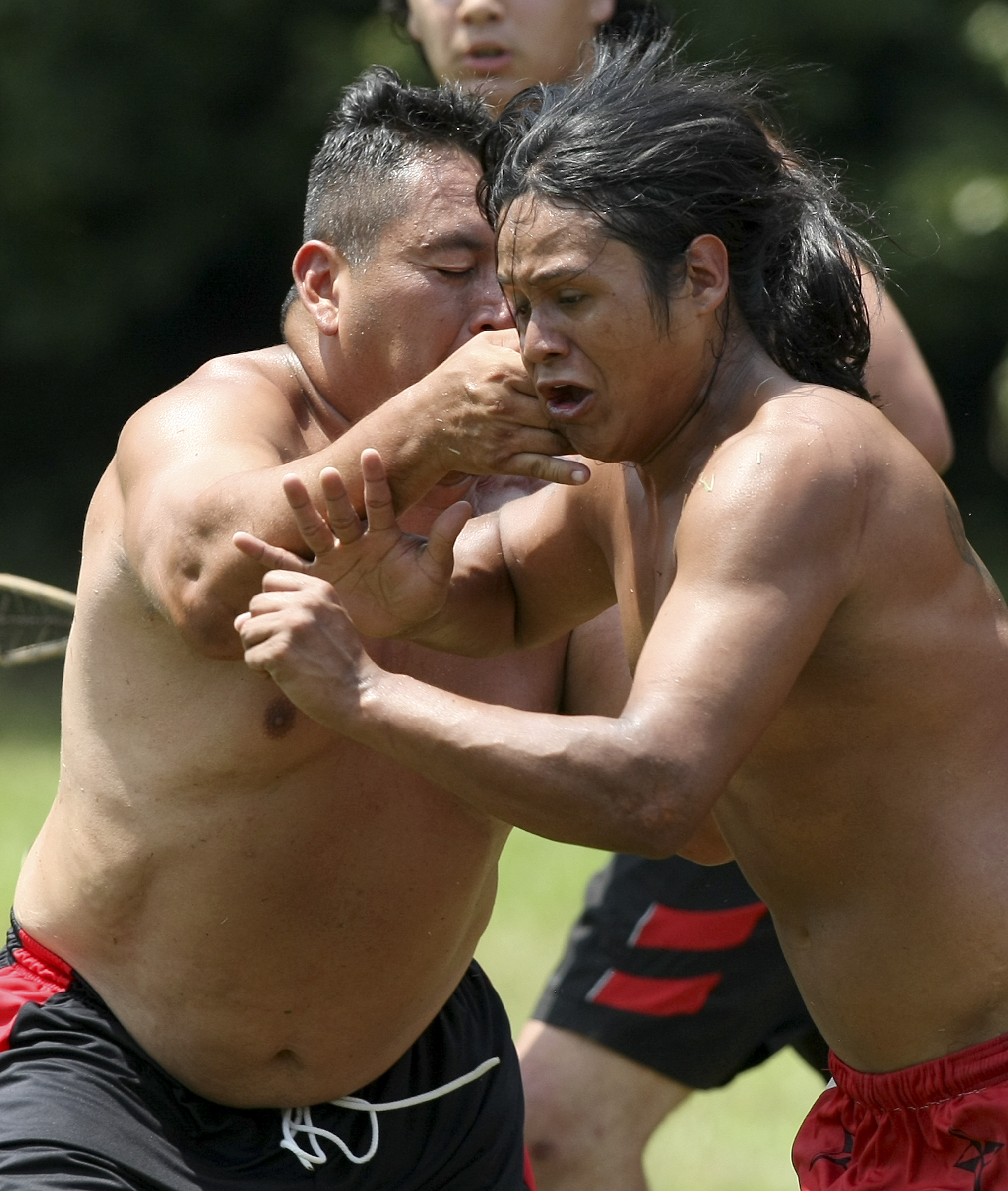 Abe Jackson, left, tries to stop Charlie Esparza during a stickball game demonstration by the Wolftown team during the 2017 Cherokee Cultural Celebration at Red Clay State Historic Park on Sunday, Aug. 6, in Cleveland, Tenn. Stickball is a traditional, full-contact Native American sport similar to lacrosse.
