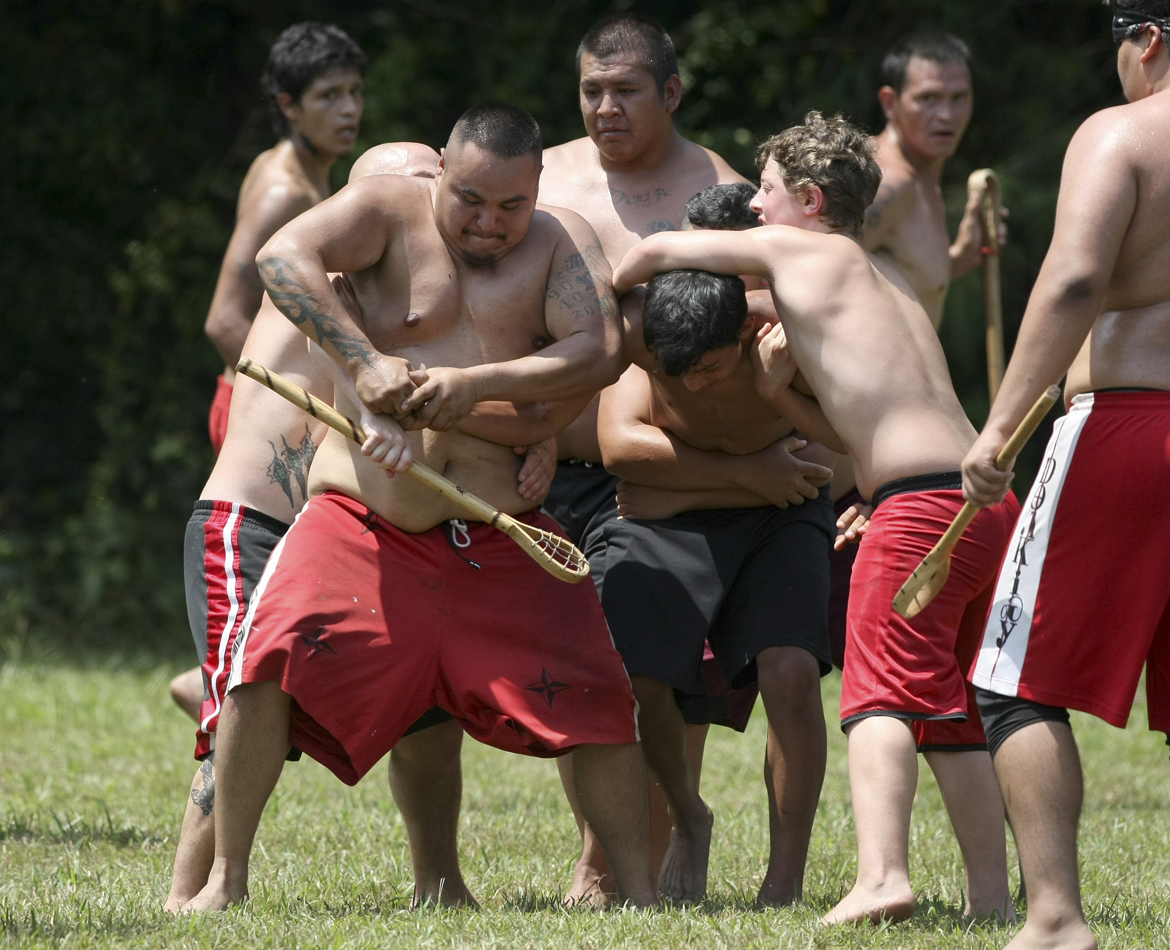 Francis Walkingstick tries to pry the ball away from an opposing player during a stickball game demonstration by the Wolftown team during the 2017 Cherokee Cultural Celebration at Red Clay State Historic Park on Sunday, Aug. 6, in Cleveland, Tenn. Stickball is a traditional, full-contact Native American sport similar to lacrosse.