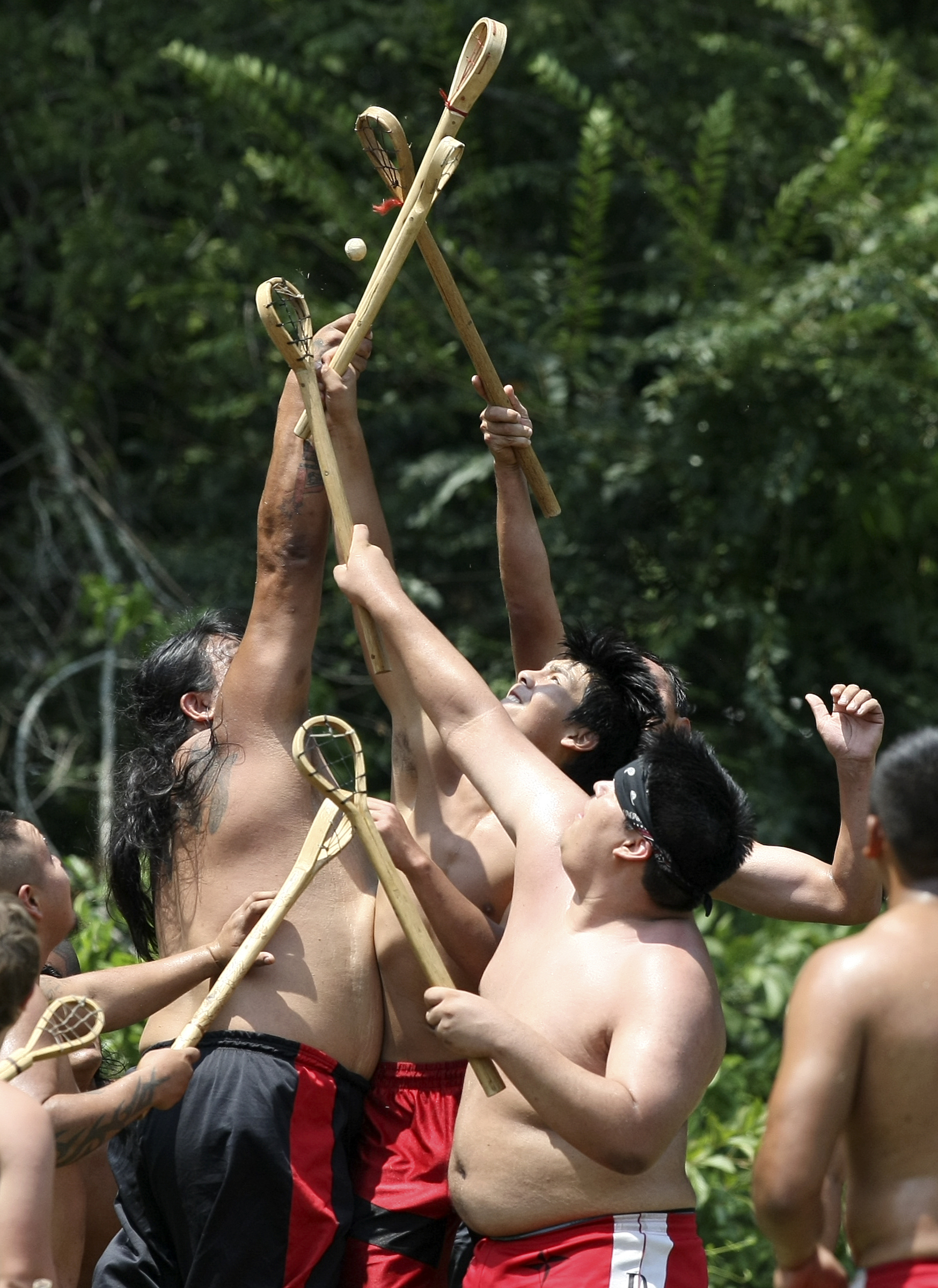 Players compete for the ball during a stickball game demonstration by the Wolftown team during the 2017 Cherokee Cultural Celebration at Red Clay State Historic Park on Sunday, Aug. 6, in Cleveland, Tenn. Stickball is a traditional, full-contact Native American sport similar to lacrosse.