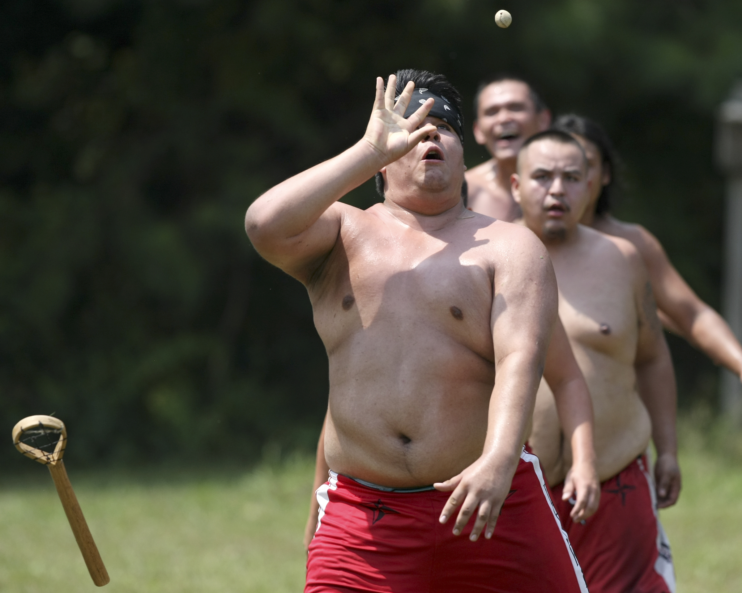 Menoch Grant drops his stick to catch the ball during a stickball game demonstration by the Wolftown team during the 2017 Cherokee Cultural Celebration at Red Clay State Historic Park on Sunday, Aug. 6, in Cleveland, Tenn. Stickball is a traditional, full-contact Native American sport similar to lacrosse.