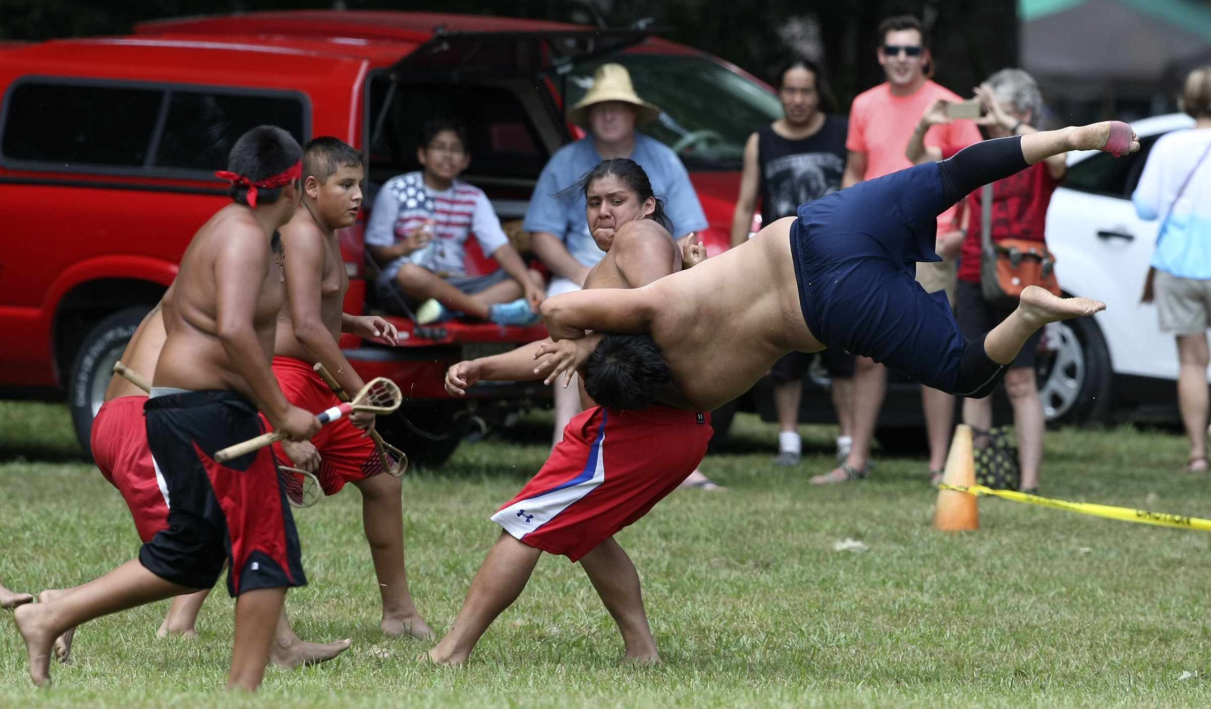 Tony Bernhisel is upended by Michael Hernandez during a stickball game demonstration by the Wolftown team during the 2017 Cherokee Cultural Celebration at Red Clay State Historic Park on Sunday, Aug. 6, in Cleveland, Tenn. Stickball is a traditional, full-contact Native American sport similar to lacrosse.