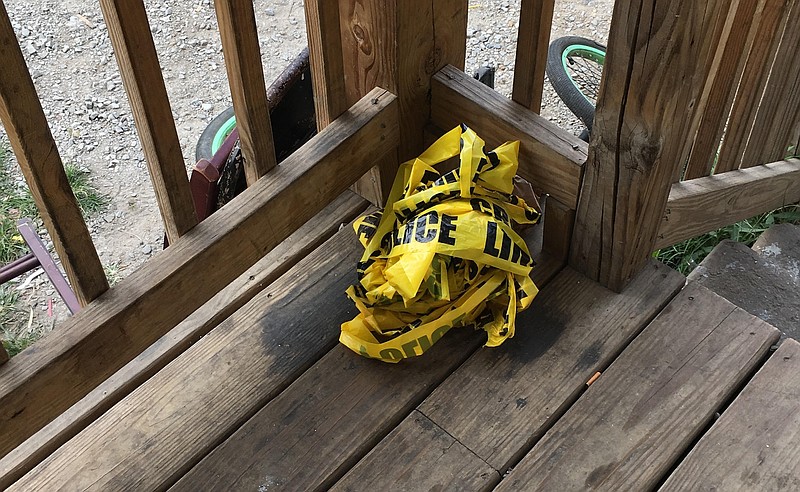 Crumpled crime scene tape is seen on the porch of a house in the 600 block of Dodson Avenue in Chattanooga. where a 7-year-old boy was injured just after 5 a.m. Sunday, Aug. 6, 2017.