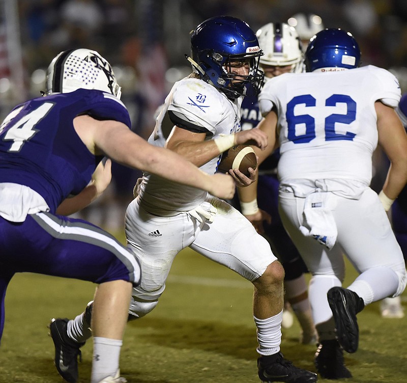 Boyd-Buchanan quarterback Kohl Henke (1) weaves through the Warrior defense.  The Boyd-Buchanan Buccaneers visited the Marion County Warriors in TSSAA football action on September 23, 2016. 