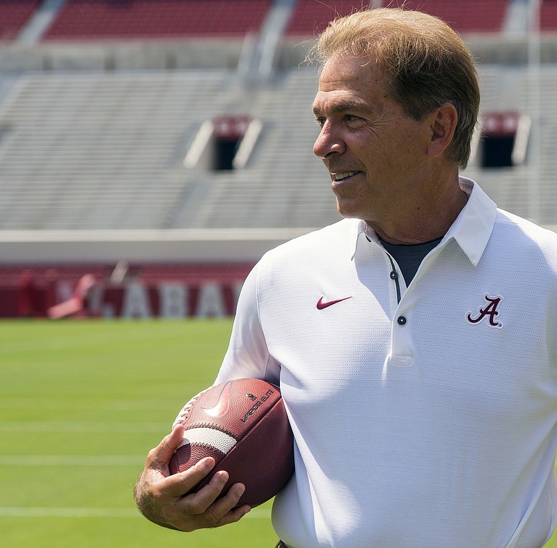 
              FILE - In this Aug. 5, 2017, file photo, Alabama head coach Nick Saban holds a football as he waits for the 2017 team picture before fan day in Tuscaloosa, Ala. Alabama remains the decisive favorite to win a fourth consecutive SEC title despite losing four first-round NFL draft picks. (Vasha Hunt/Alabama Media Group via AP, File)
            