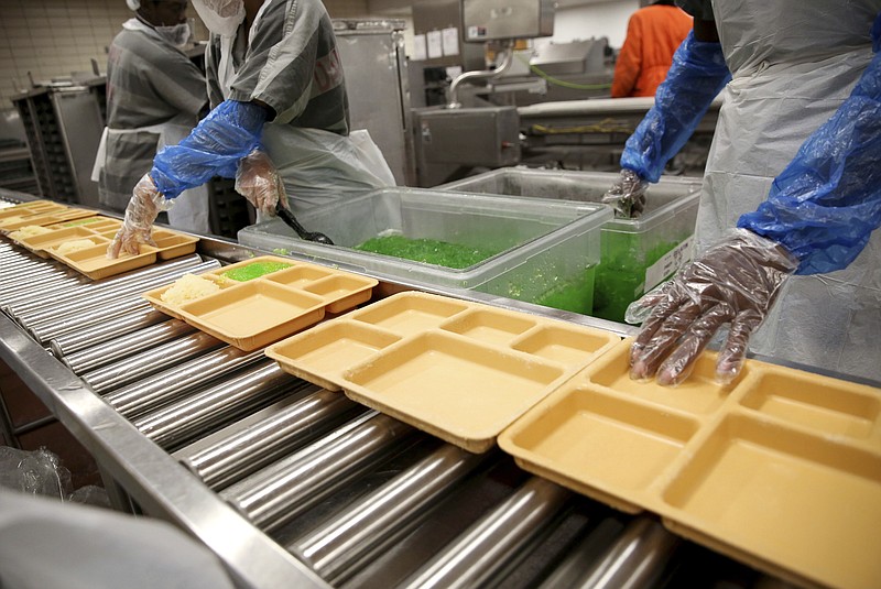 
              In this Wednesday, July 26, 2017, photo, inmates serve pineapple and lime gelatin at the Lew Sterrett Justice Center in Dallas. Low-level inmates known as trusties prepare food for the Dallas County adult and juvenile facilities. (Rose Baca/The Dallas Morning News via AP)
            