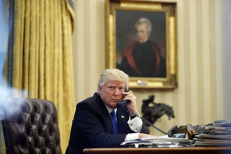 FILE - In this Jan. 28, 2017 file photo, President Donald Trump speaks on the phone with Prime Minister of Australia Malcolm Turnbull in the Oval Office of the White House in Washington. (AP Photo/Alex Brandon, File)