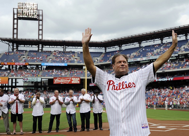 
              FILE- In this Aug 3, 2013, file photo, former Philadelphia Phillies catcher Darren Daulton waves to the crowd as he takes the field during the Philadelphia Phillies Alumni ceremonies before a baseball game against the Atlanta Braves in Philadelphia. Daulton, the All-Star catcher who was the leader of the Phillies' NL championship team in 1993, has died. He was 55. (AP Photo/Michael Perez, File)
            