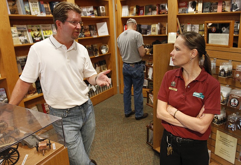 Steven McCloud, left, president and CEO of Trident Leadership, a business management consulting company, speaks to bookstore manager Marie Maquar while in the Chickamaga National Battlefield bookstore where he brings clients to relate historic battlefield leadership lessons to those in the modern workplace.