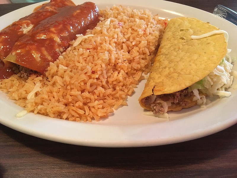 The enchilada/taco combo plate includes tortillas filled with a hefty serving of pulled chicken sauteed in onions and peppers and smothered in red sauce.