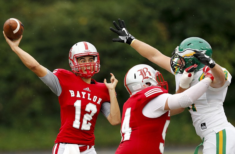 Baylor offensive lineman Cole Johnson, center, blocks Rhea County defensive lineman Bradley Evans as Baylor quarterback Lorenzo White (12) passes during their prep football game at Baylor School on Friday, Aug. 19, 2016, in Chattanooga, Tenn.