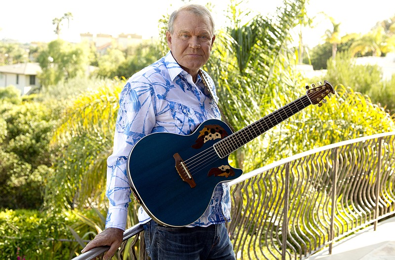 
              FILE - In this July 27, 2011 photo, musician Glen Campbell poses for a portrait in Malibu, Calif. Campbell, the grinning, high-pitched entertainer who had such hits as "Rhinestone Cowboy" and spanned country, pop, television and movies, died Tuesday, Aug. 8, 2017. He was 81. Campbell announced in June 2011 that he had been diagnosed with Alzheimer's disease. (AP Photo/Matt Sayles, File)
            