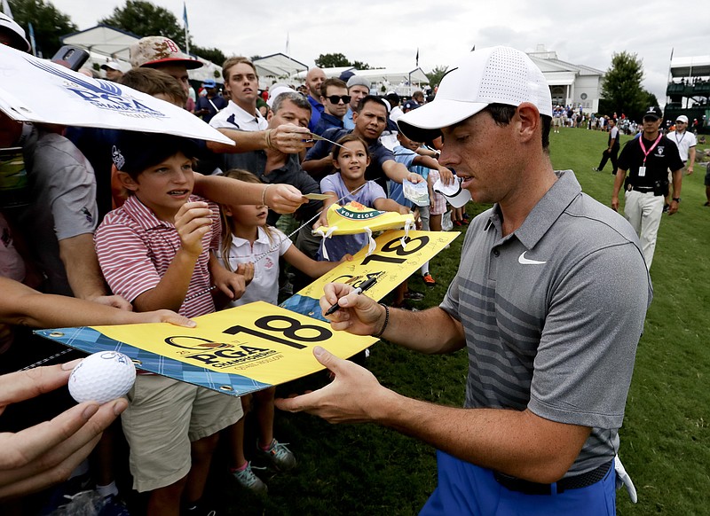 
              Rory McIlroy of Northern Ireland, sign autographs after a practice round at the PGA Championship golf tournament at the Quail Hollow Club Tuesday, Aug. 8, 2017, in Charlotte, N.C. (AP Photo/Chris Carlson)
            