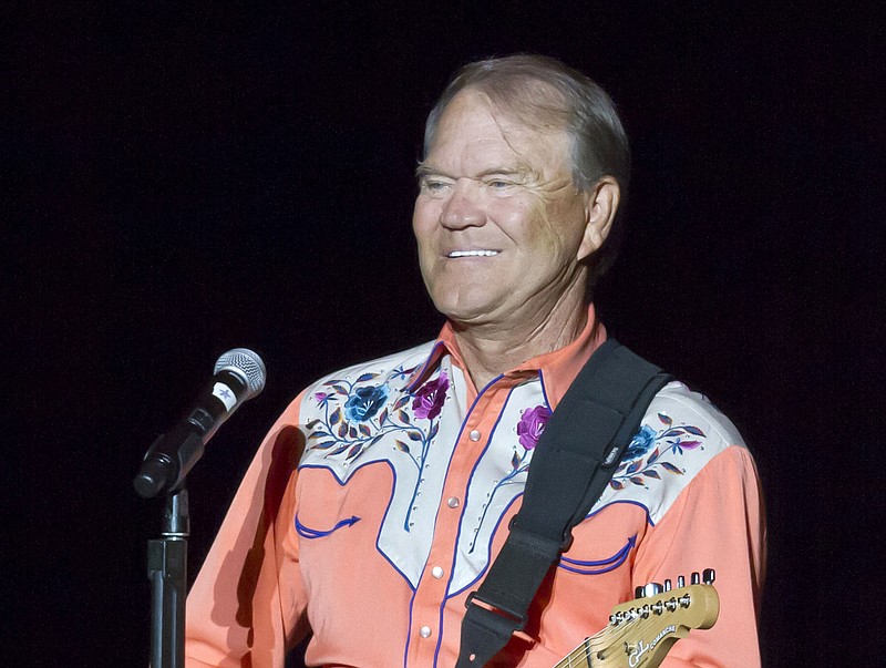 
              FILE - This Sept. 6, 2012 file photo shows singer Glen Campbell performing during his Goodbye Tour in Little Rock, Ark. Campbell, the grinning, high-pitched entertainer who had such hits as "Rhinestone Cowboy" and spanned country, pop, television and movies, died Tuesday, Aug. 8, 2017. He was 81. Campbell announced in June 2011 that he had been diagnosed with Alzheimer's disease. (AP Photo/Danny Johnston, File)
            