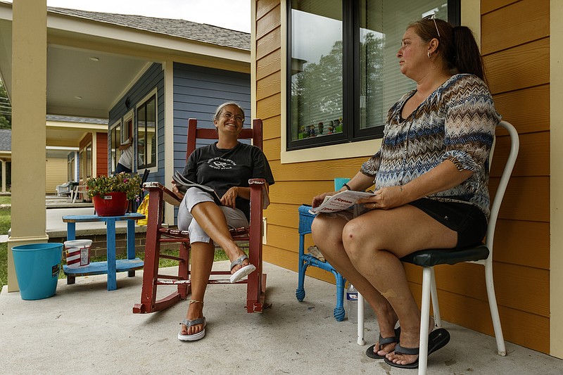 Chassey Wooten, left, and Martha Massey sit on the porch of Wooten's Chamberlain Avenue home on Wednesday, Aug. 9, 2017, in Chattanooga, Tenn. Wooten and Massey both live in homes on the street built by Tower Construction partly through a city funding grant. The City of Chattanooga's Department of Economic & Community Development is working with various agencies to create more affordable housing in the city.