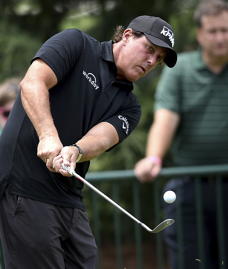 
              Phil Mickelson watches the flight of his ball during practice for the PGA Championship golf tournament at Quail Hollow Club in Charlotte, N.C., Monday, Aug. 7, 2017. (Jeff Siner/The Charlotte Observer via AP)
            