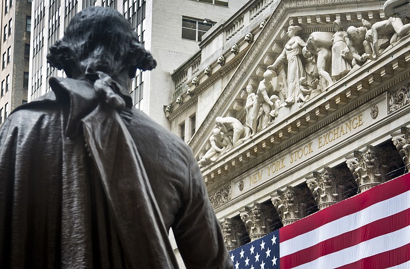 
              FILE - In this Wednesday, July 8, 2015, file photo, Federal Hall's George Washington statue stands near the flag-covered pillars of the New York Stock Exchange. U.S. stock indexes edged lower in early trading Tuesday, Aug. 8, 2017, pulling back from the market’s most recent record highs. Health care and consumer-focused companies were among the biggest laggards. Energy stocks also fell as crude oil prices headed lower. Banks and utilities had some of the biggest gains. (AP Photo/Bebeto Matthews, File)
            