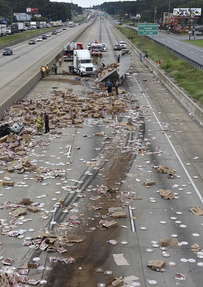 
              This Aug. 9, 2017 photo provided by the Arkansas Department of Transportation shows Arkansas highway Interstate 30, a cross-country route that was shut down in both directions for a time Wednesday, after an 18-wheeler was sliced open during an accident and spilled frozen pizzas across the road south of Little Rock, Ark. The interstate, was closed for several hours while crews cleaned up the mess. (Rusty Hubbard, Arkansas Department of Transportation via AP)
            