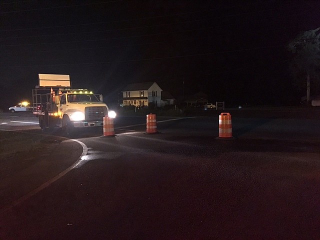 A truck is on the scene of a water main break on Wednesday that has temporarily closed McCallie Ferry Road.