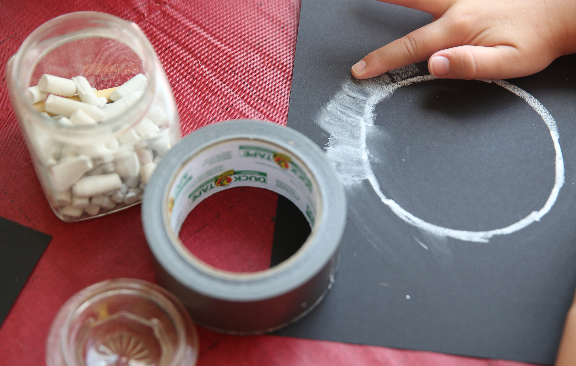 Lila Higdon, 6, makes an eclipse chalk drawing at her grandparents' house Tuesday, Aug. 8, 2017, in Soddy-Daisy, Tenn. Family members were preparing decorations and souvenirs for guests who attend their Great American Eclipse party next week.