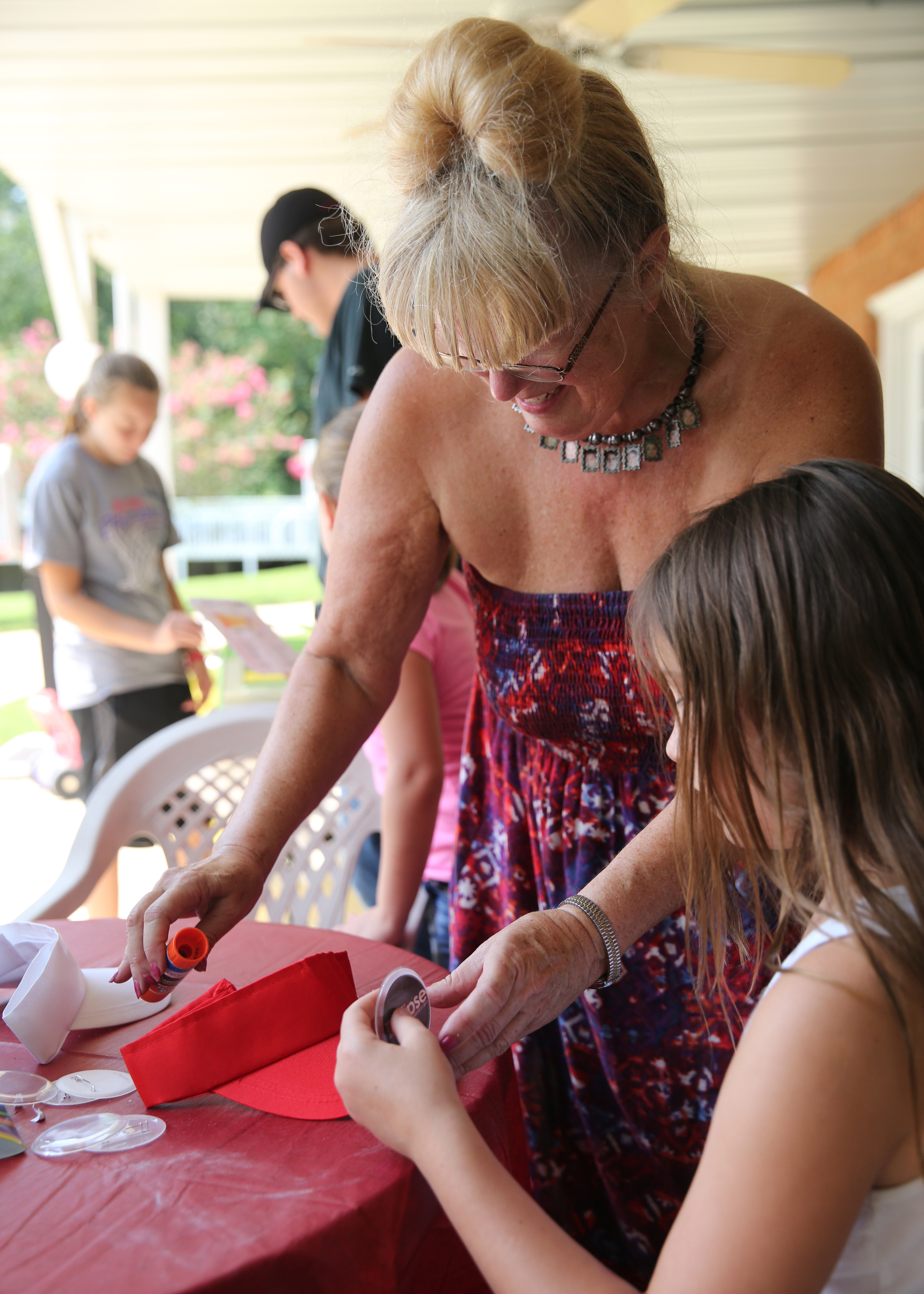 Jeanette Esch helps her granddaughter Aurora Esch, 9, put buttons on visors at Jeanette's house Tuesday, Aug. 8, 2017, in Soddy-Daisy, Tenn. Jeanette and her grandkids were preparing decorations and souvenirs for guests who attend their Great American Eclipse party next week.