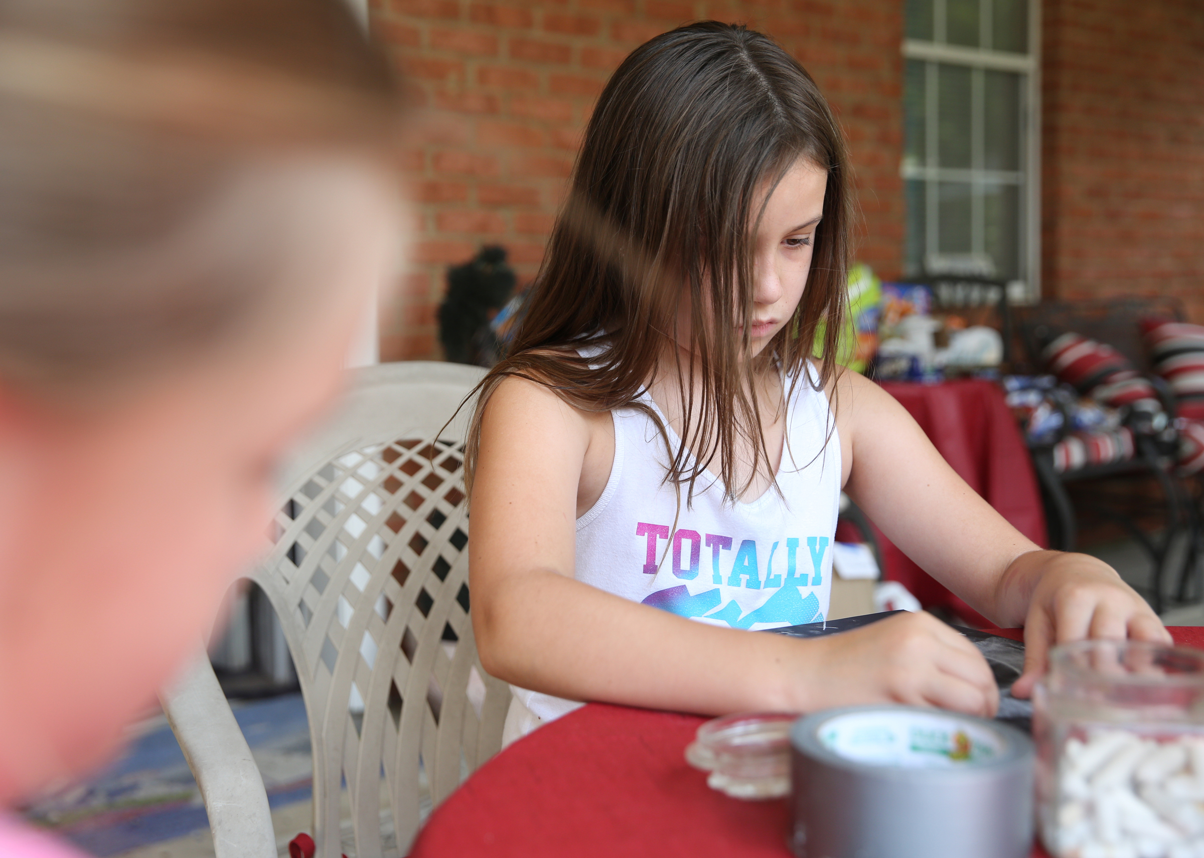 Aurora Esch, 9, works on a chalk drawing of the eclipse at her grandparents' house Tuesday, Aug. 8, 2017, in Soddy-Daisy, Tenn. Aurora and other family members were preparing decorations and souvenirs for guests who attend their Great American Eclipse party next week.