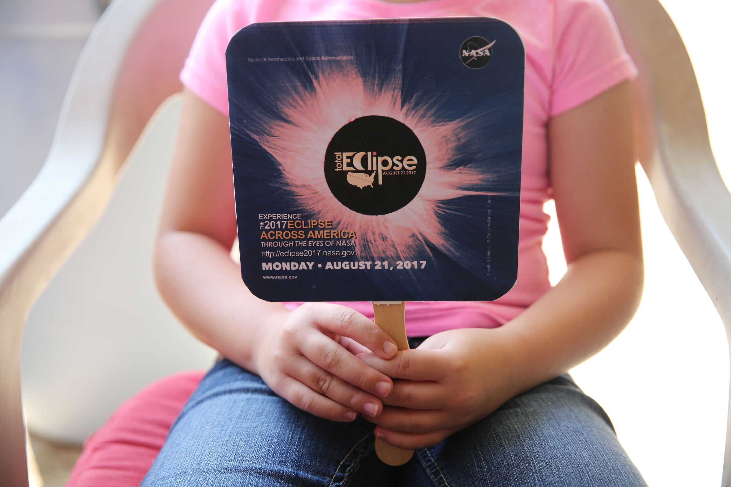 Lila Higdon, 6, holds up a fan she made with information about the lunar eclipse at her grandparents' house Tuesday, Aug. 8, 2017, in Soddy-Daisy, Tenn. Higdon's grandmother is having an eclipse-themed party on the day of the total lunar eclipse.