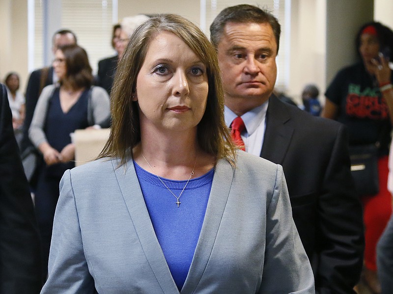 
              FILE - In this May 17, 2017, file photo, Betty Shelby leaves the courtroom with her husband, Dave Shelby, right, after the jury in her case began deliberations in Tulsa, Okla. Shelby, a former Tulsa police officer who resigned after being acquitted of manslaughter in the fatal shooting of an unarmed black man, is going to work for the sheriff's office in neighboring Rogers County. (AP Photo/Sue Ogrocki, File)
            