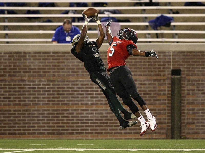 Notre Dame's Cameron Wynn catches the ball over Signal Mountain's Travion Williams for a 21-yard gain during the Best of Preps Kickoff Classic jamboree Friday night at Finley Stadium.