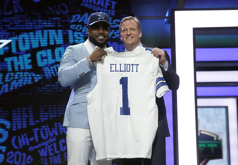 
              FILE - In this April 28, 2016, file photo, Ohio State's Ezekiel Elliott poses for photos with NFL commissioner Roger Goodell after being selected by the Dallas Cowboys as the fourth pick in the first round of the 2016 NFL football draft, in Chicago. Elliott has been suspended for six games under the NFL’s personal conduct policy following the league’s yearlong investigation into the star Dallas Cowboys running back’s domestic violence case out of Ohio.  The league said Friday, Aug. 11, 2017, there was “substantial and persuasive evidence” that Elliott had physical confrontations last summer with his ex-girlfriend, Tiffany Thompson.(AP Photo/Charles Rex Arbogast, File)
            