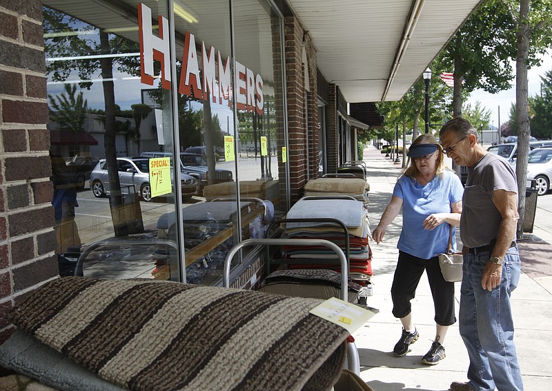 Charles and Yolonda Wood shop for rugs outside of Hammer's store on Thursday, July 17, 2014, in South Pittsburg, Tenn.