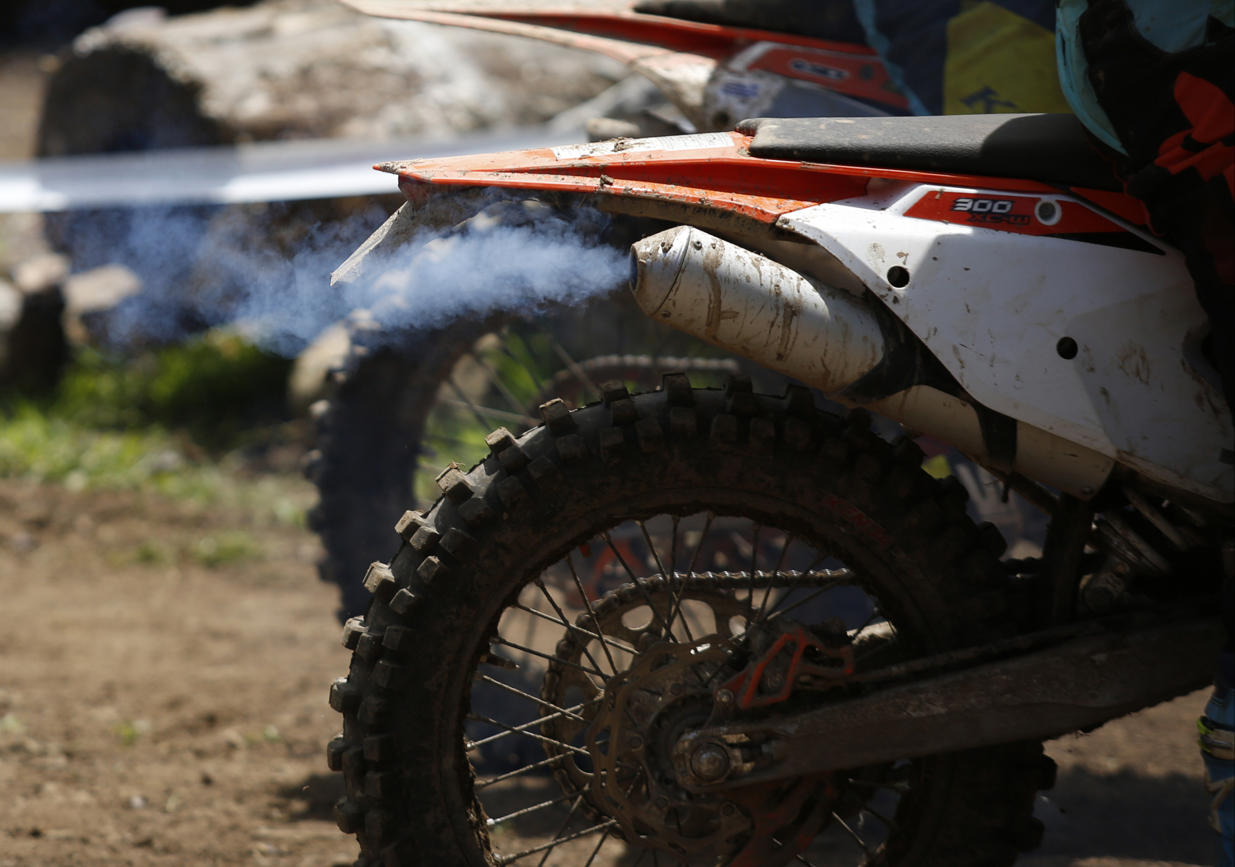 A competitor's bike exhausts smoke during the Kenda AMA Tennessee Knockout Extreme Enduro road race amateur qualifier at Trials Training Center on Saturday, Aug. 12, 2017, in Sequatchie, Tenn. The top 30 qualifiers in Saturdays races will compete alongside professionals on Sunday.
