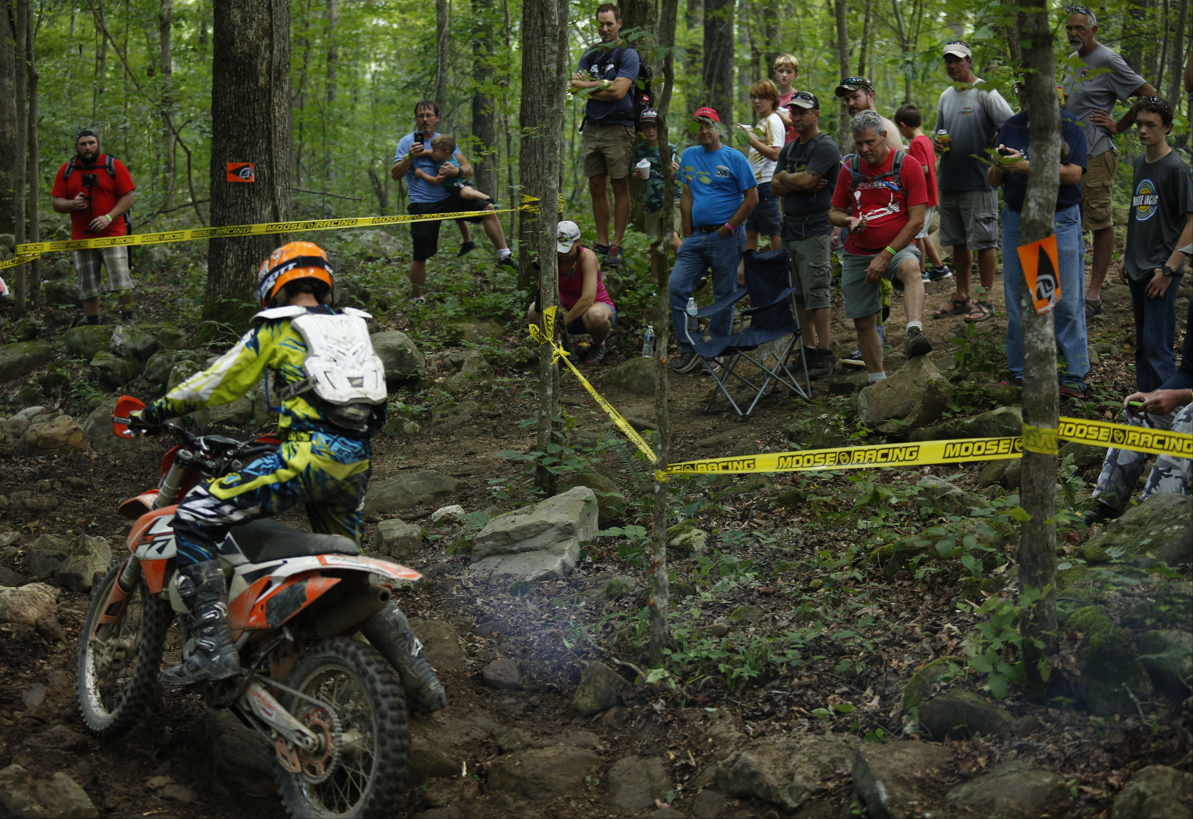A crowd watches a competitor navigate rough terrain while competing in the Kenda AMA Tennessee Knockout Extreme Enduro road race amateur qualifier at Trials Training Center on Saturday, Aug. 12, 2017, in Sequatchie, Tenn. The top 30 qualifiers in Saturdays races will compete alongside professionals on Sunday.