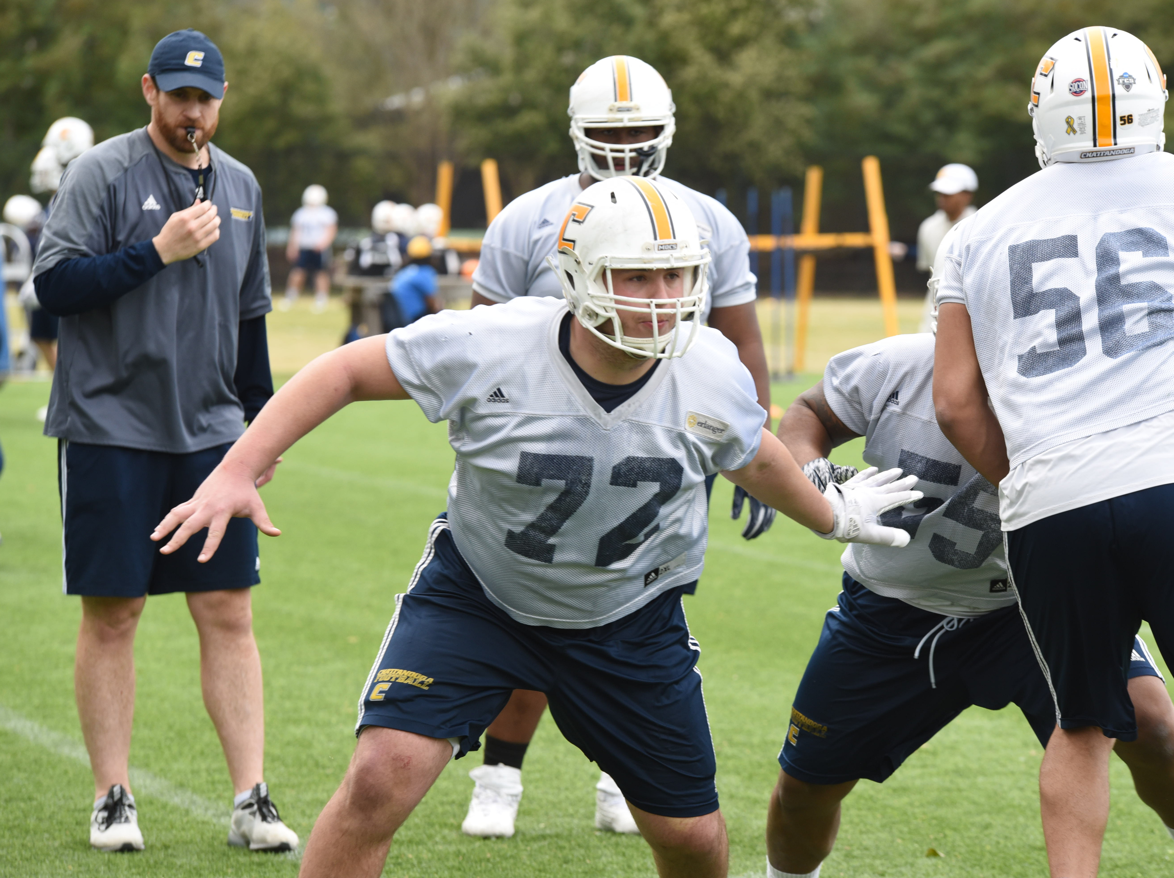 Offensive line coach Nick Hennessee, left, watches as right guard Josh Cardiello works on the second day of spring practice at Scrappy Moore Field.