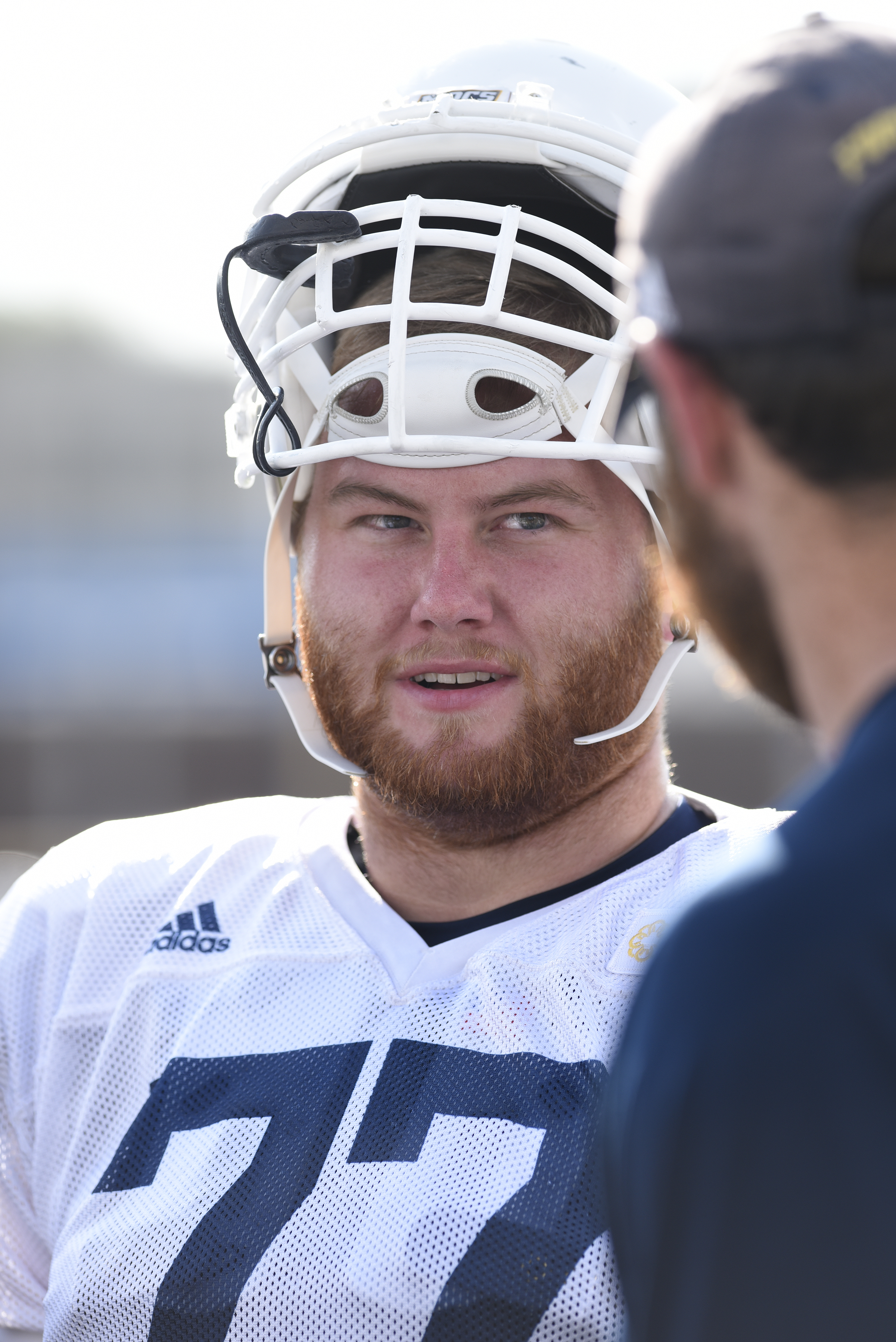 UTC offensive lineman Taylor Helton talks to the line coach, Nick Hennessy. The UTC football team practiced at Finley Stadium on August 10, 2017.