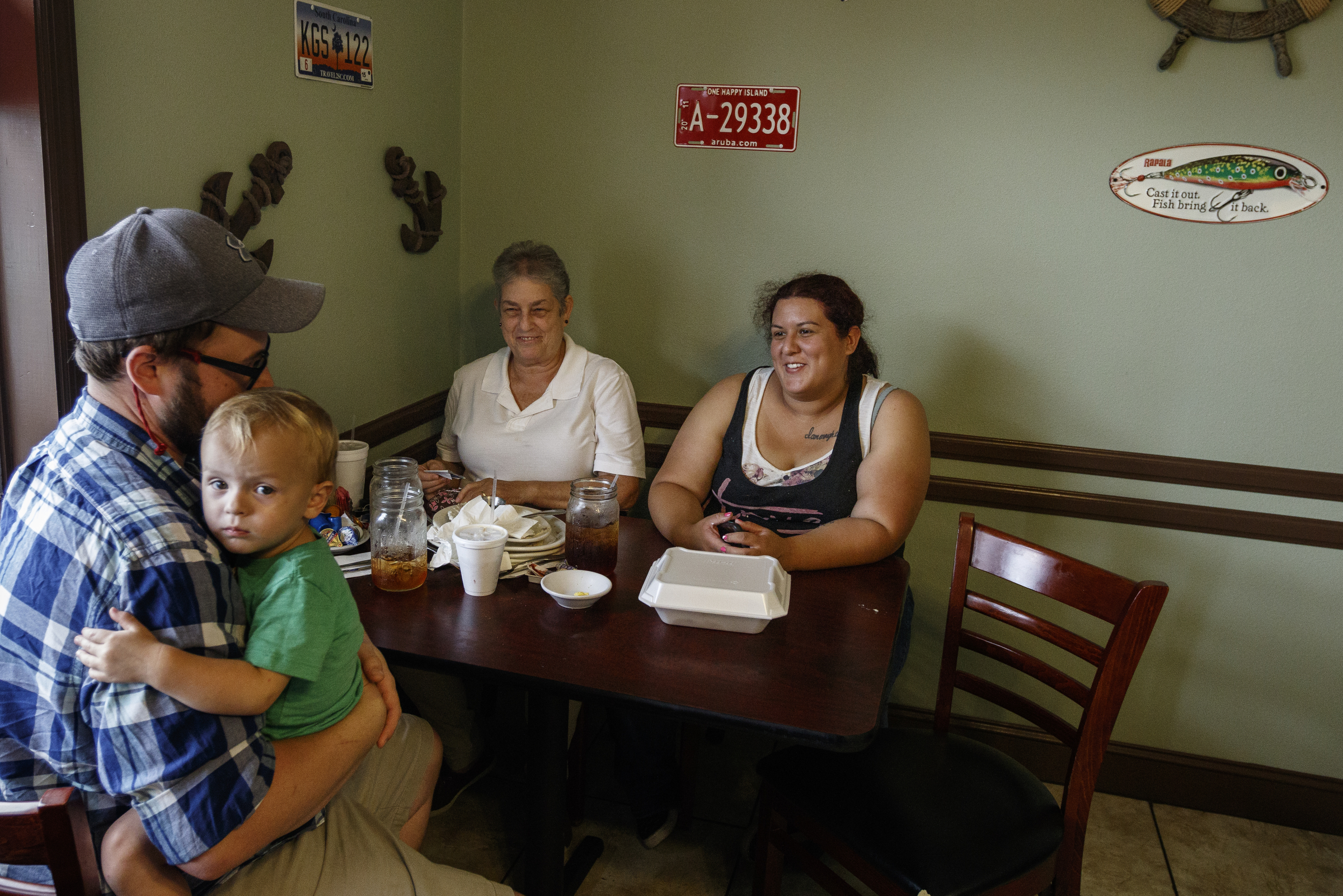 Michael Estep holds Julie Estep, left, as they dine with Pat Vizueth, center, and Sheena Estep at Scramblez Cafe on Friday, Aug. 11, 2017, in Spring City, Tenn. On August 21, thousands are expected to flock to the small Rhea County town, which is home to about 2000 residents, to view the solar eclipse.