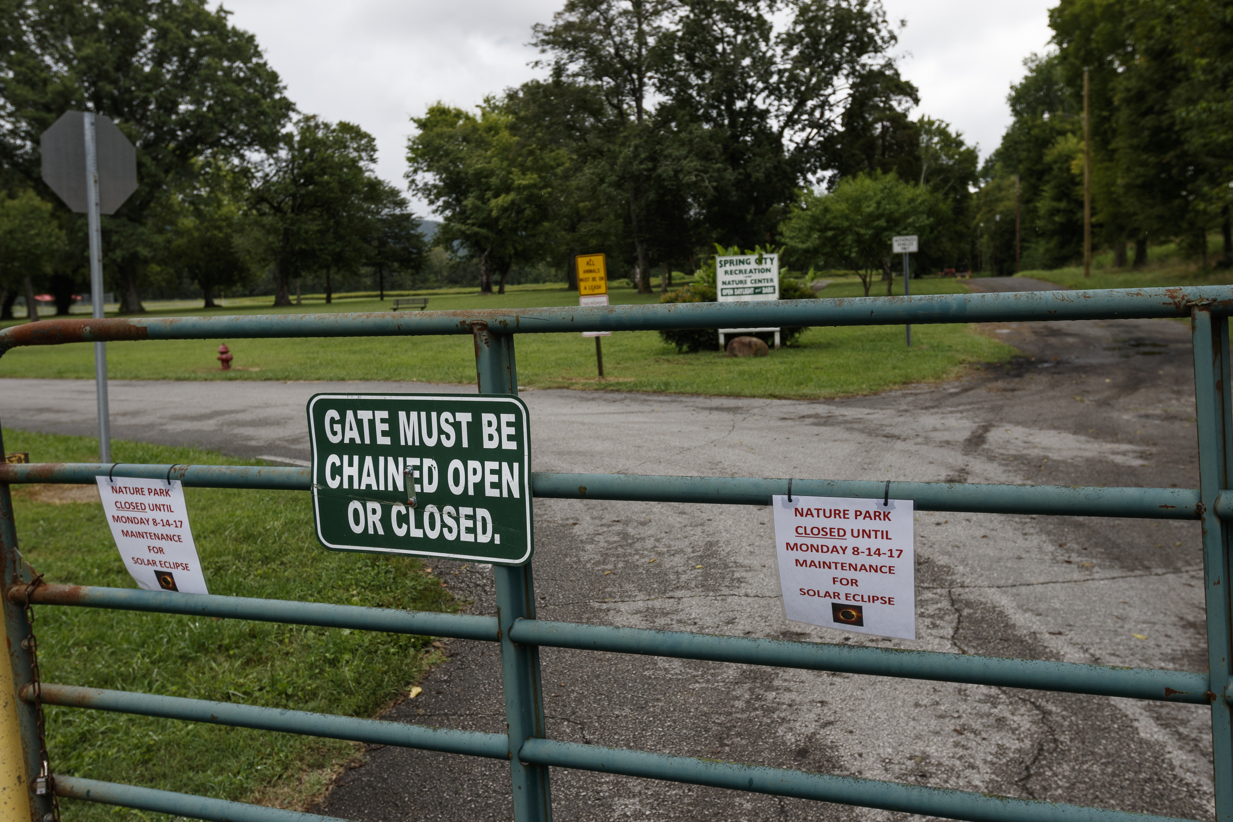 Signs on the gates of the Spring City Nature Park indicate it is closed for maintenance in preparation for the upcoming eclipse on Friday, Aug. 11, 2017, in Spring City, Tenn. On August 21, thousands are expected to flock to the small Rhea County town, which is home to about 2000 residents, to view the solar eclipse.
