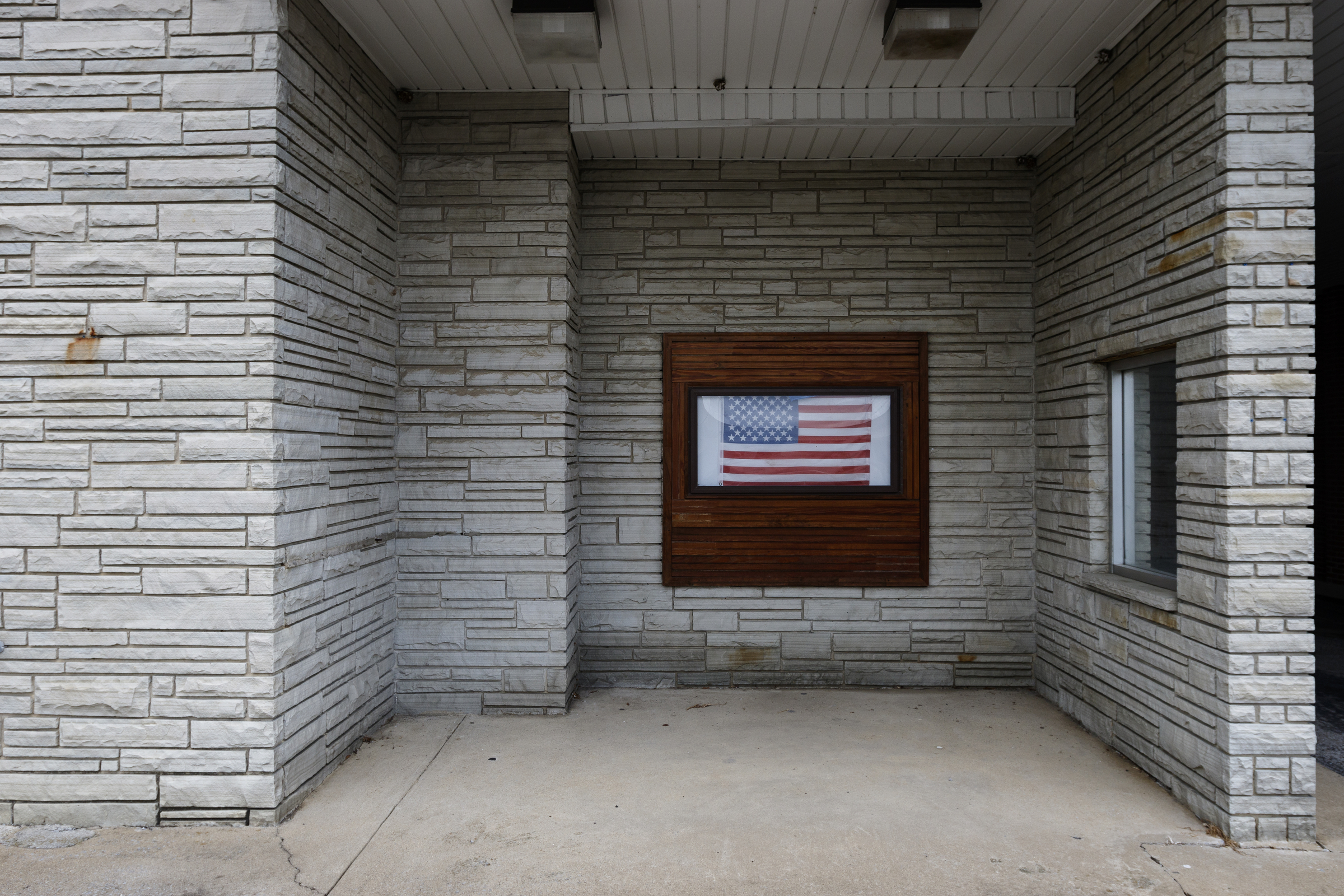 A flag hangs in a window of the Spring City History Museum's annex on Friday, Aug. 11, 2017, in Spring City, Tenn. On August 21, thousands are expected to flock to the small Rhea County town, which is home to about 2000 residents, to view the solar eclipse.