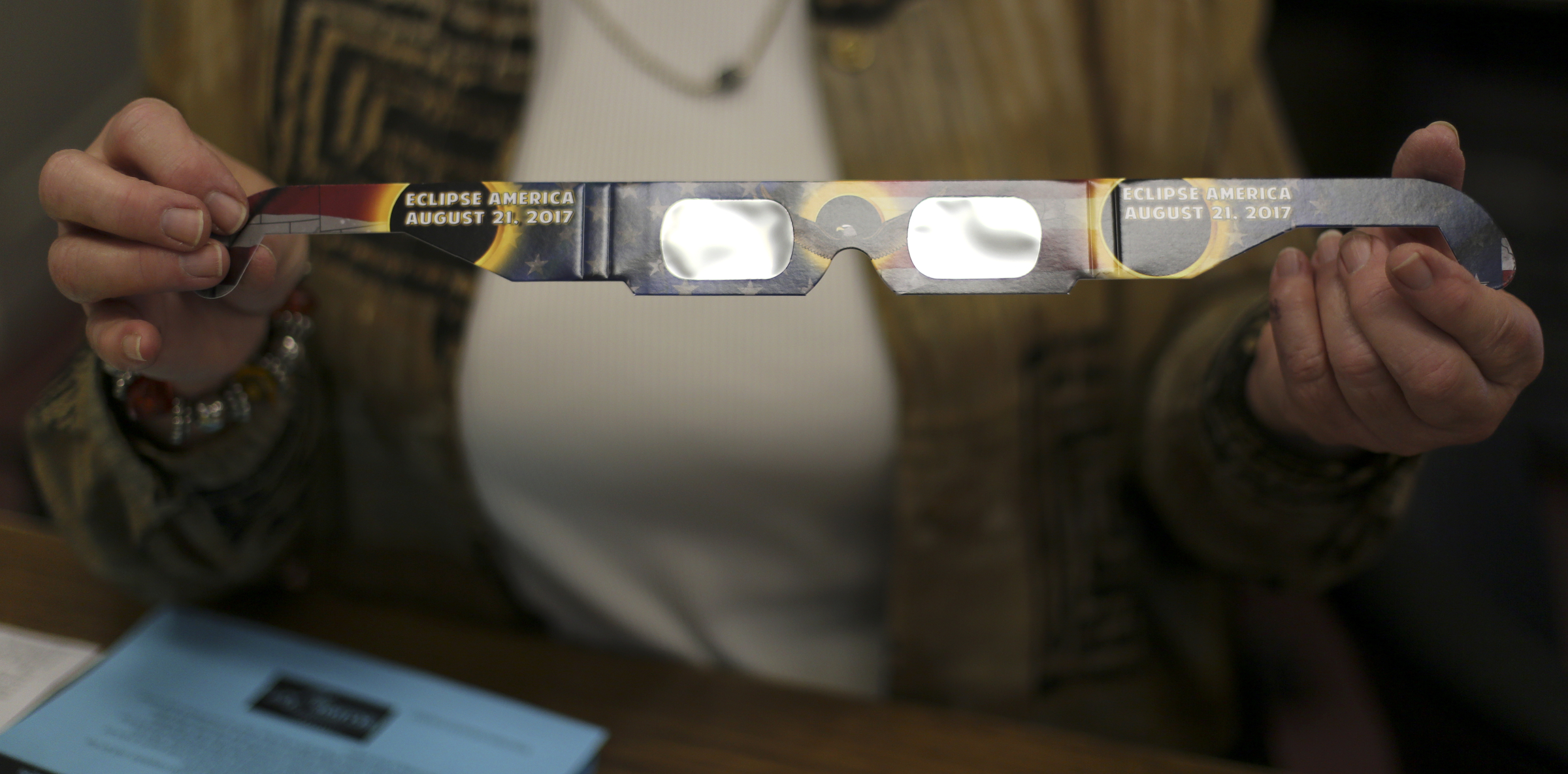 Library Assistant Linda Powell holds up a pair of eclipse glasses at the Sequatchie County Public Library on Wednesday, Aug. 9, in Dunlap, Tenn. The library is giving away the glasses for free, first to library card holders and then to the general public.