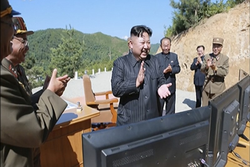 
              This image made from video of a news bulletin aired by North Korea's KRT on Tuesday, July 4, 2017, shows what was said to be North Korea leader Kim Jung Un, center, applauding after the launch of a Hwasong-14 intercontinental ballistic missile, ICBM, in North Korea's northwest. North Korea’s announcement that it is finalizing a plan to launch four ballistic missiles over Japan toward the island of Guam has touched off a series of fiery threats from President Donald Trump and upped tensions between Pyongyang and Washington to a whole new level. (KRT via AP Video)
            