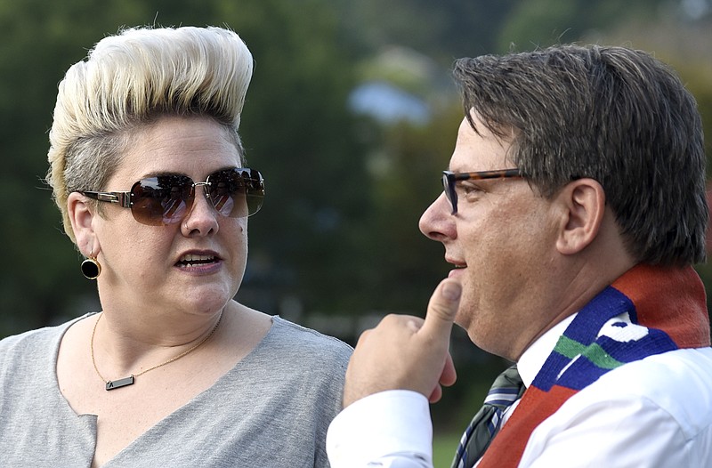 From left, Anna Golladay, who was in Charlottesville, Virginia, when the violence erupted speaks with Brian Merritt, pastor of Renaissance Presbyterian Church.  The Chattanooga Democratic Socialists hosted a candlelight vigil for Heather Heyer and Charlottesville at Coolidge Park on August 13, 2017.  