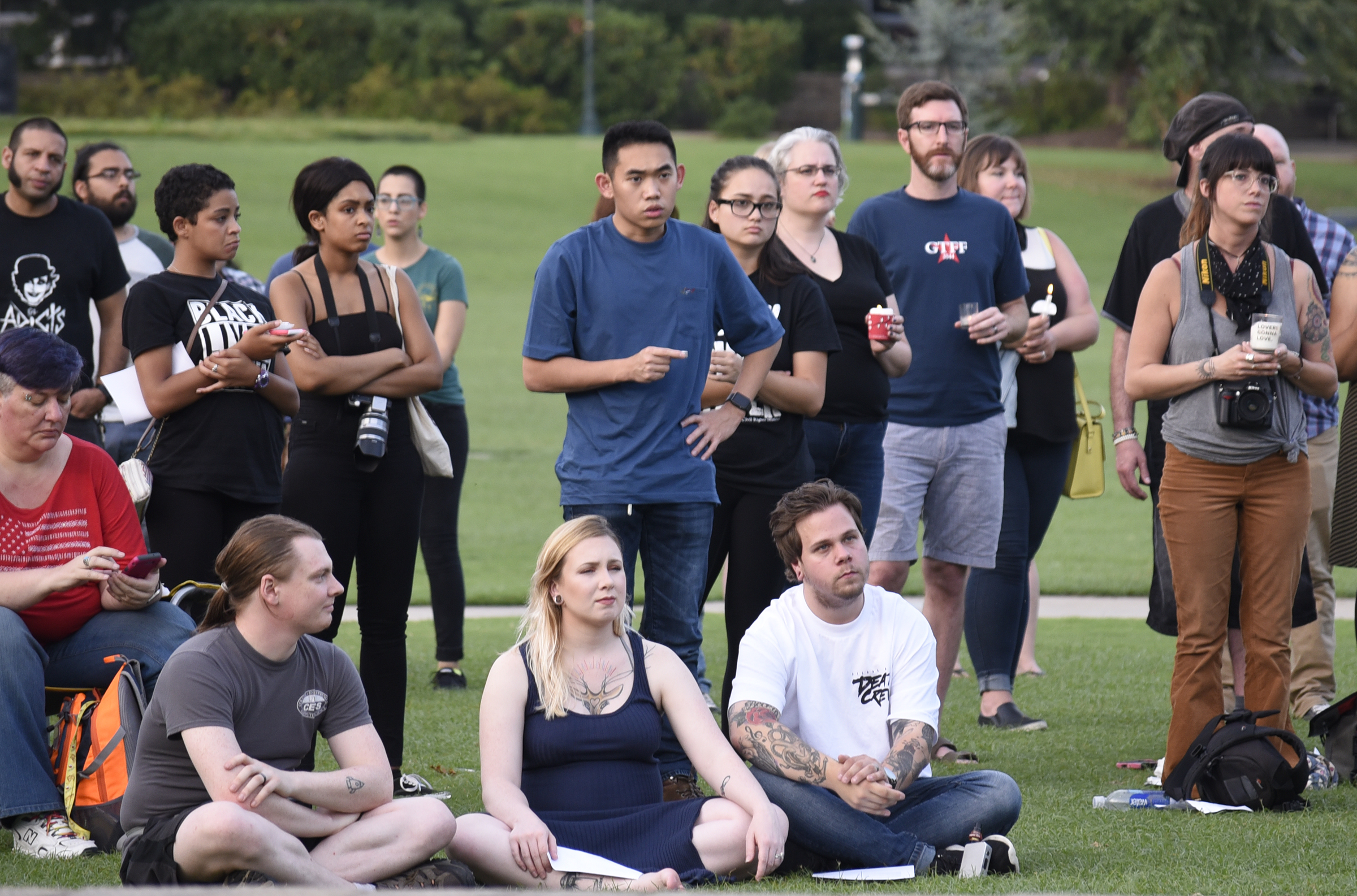 People listen to speakers and hold candles at a vigil remembering the recent violence in Charlottesville, Virginia. The Chattanooga Democratic Socialists hosted a candlelight vigil for Heather Heyer and Charlottesville at Coolidge Park on August 13, 2017.