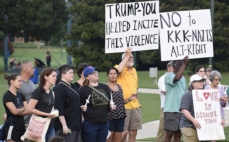 People listen to speakers, hold candles and display signs at a vigil remembering the recent violence in Charlottesville, Virginia.  The Chattanooga Democratic Socialists hosted a candlelight vigil for Heather Heyer and Charlottesville at Coolidge Park on August 13, 2017.  