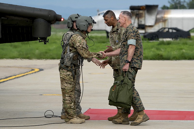 
              Joint Chiefs Chairman Gen. Joseph Dunford, right, and United States Forces Korea Commander Gen. Vincent Brooks, second from right, greets a helicopter flight crew as he arrives at Osan Air Base, Sunday, Aug. 13, 2017, in Pyeongtaek, South Korea. (AP Photo/Andrew Harnik)
            