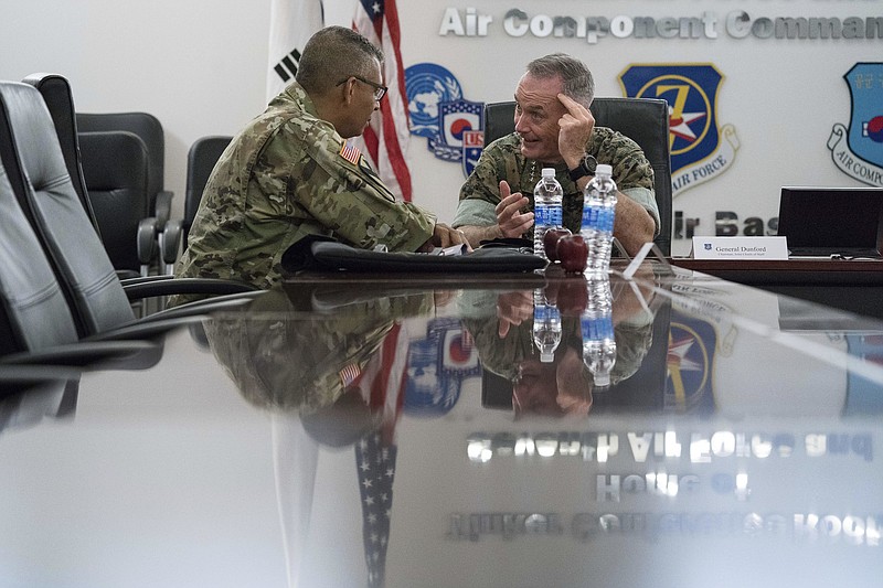 
              Joint Chiefs Chairman Gen. Joseph Dunford, right, speaks with United States Forces Korea Commander Gen. Vincent Brooks, left, at Osan Air Base, Sunday, Aug. 13, 2017, in Pyeongtaek, South Korea. (AP Photo/Andrew Harnik)
            