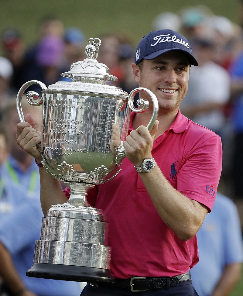 Justin Thomas poses with the Wanamaker Trophy after winning the PGA Championship golf tournament at the Quail Hollow Club Sunday, Aug. 13, 2017, in Charlotte, N.C. (AP Photo/Chris O'Meara)