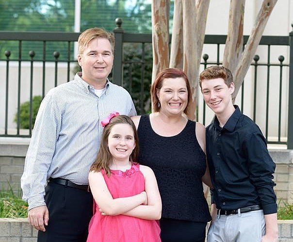 Signal Mountain native Amy Brock, author of "Being Cancer Happy," gathers for a family photo with her husband and children. From left are Marcus, Callie and Amy Brock and Jackson Fields. (Contributed photo)