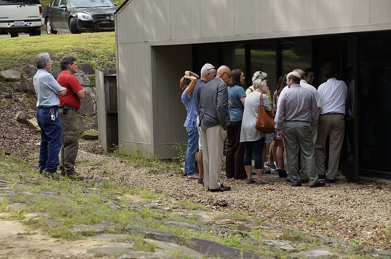 Residents stranded outside Signal Mountain Town Hall strain to hear a public feedback forum regarding a developer's proposal to build a "big box" grocery store nearby. With the meeting room packed, many attendees were left to look and listen in from outside. (Staff photo by Myron Madden)