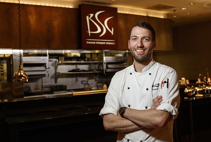 Broad Street Grille executive chef Tanner Marino, the youngest executive chef in the restaurant's history, poses for a portrait in front of the kitchen on Friday, Aug. 4, 2017, in Chattanooga, Tenn.