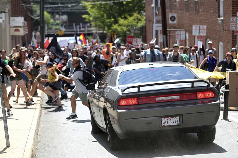 A vehicle drives into a group of protesters demonstrating against a white nationalist rally in Charlottesville, Va., Saturday.