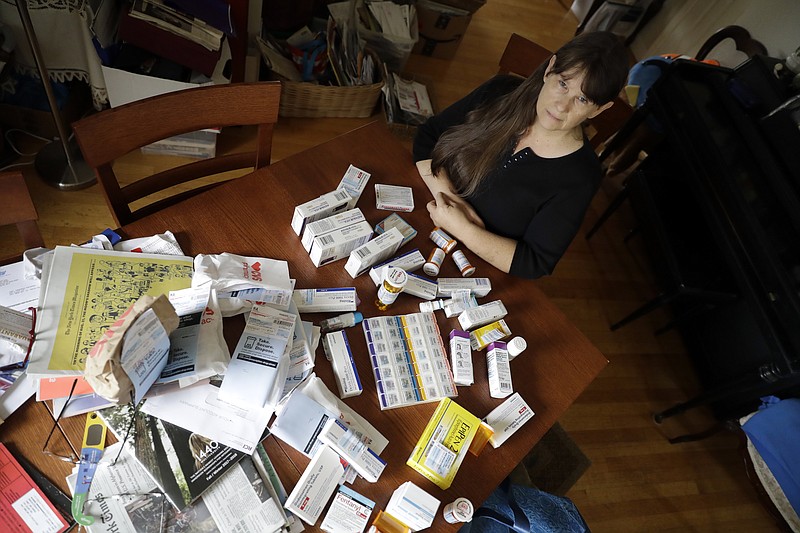 
              In this Aug. 10, 2017, photo, Sara Hayden poses for a photo with some of her medications at home in Half Moon Bay, Calif. Hayden lost her job as a data researcher because of medical problems and is now covered by Medi-Cal, as Medicaid is called in California. She has rheumatoid arthritis, and the medication she has to take to keep the disease in check cost thousands of dollars a month. The Medicaid program is a 1960s Great Society creation long criticized by conservatives. But it seems to have emerged even stronger after the Republican failure to pass health overhaul legislation. (AP Photo/Marcio Jose Sanchez)
            